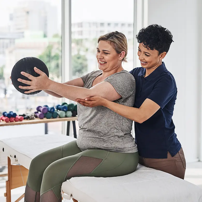 Patient receiving post-surgical rehabilitation from a physical therapist.